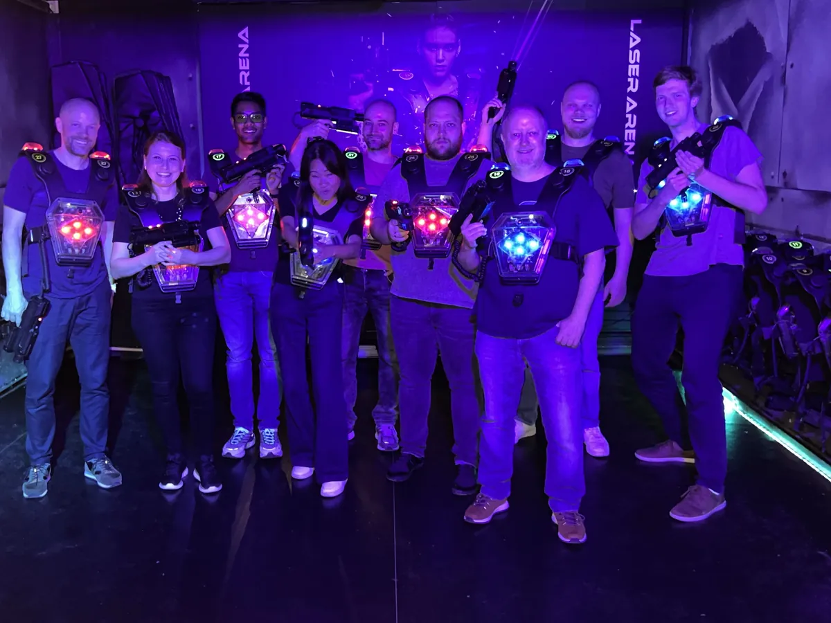 The Theia team in laser tag vests in a laser arena